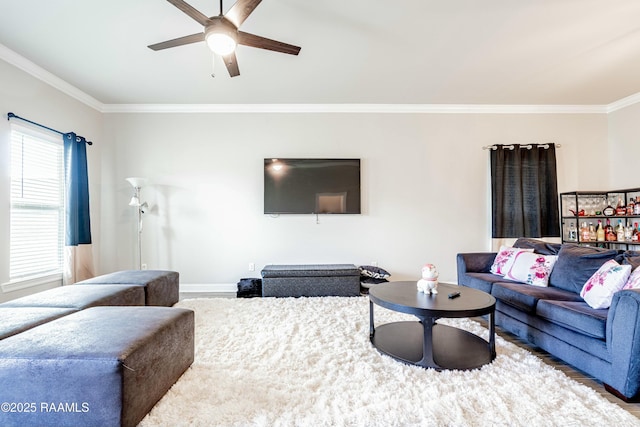 living area featuring ornamental molding, baseboards, and ceiling fan
