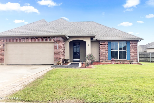 ranch-style house with an attached garage, a shingled roof, a front yard, and brick siding
