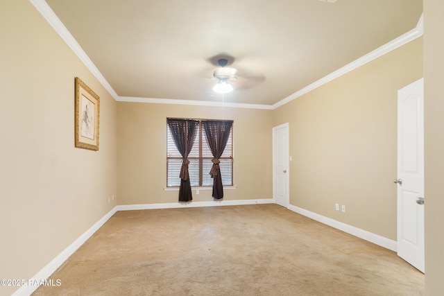 empty room featuring crown molding, baseboards, a ceiling fan, and carpet