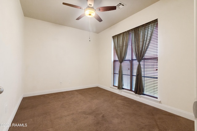 spare room featuring visible vents, baseboards, a ceiling fan, and carpet floors