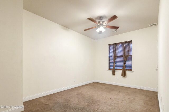unfurnished room featuring carpet flooring, baseboards, a ceiling fan, and visible vents