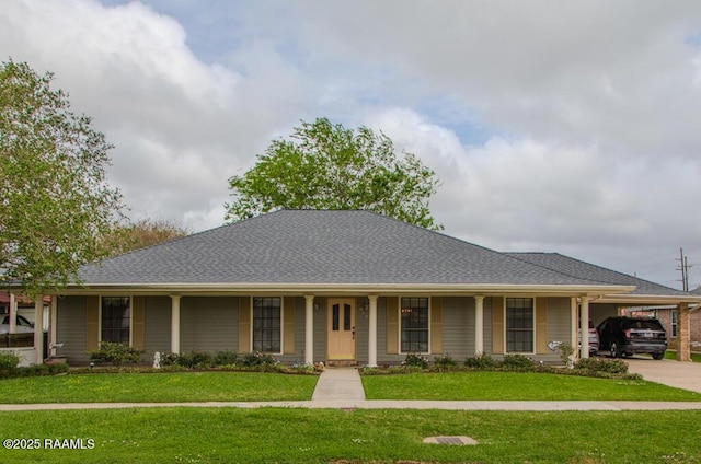 ranch-style home featuring concrete driveway, an attached carport, and a front lawn