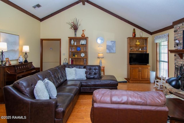 living area featuring visible vents, light wood-type flooring, a fireplace, and lofted ceiling