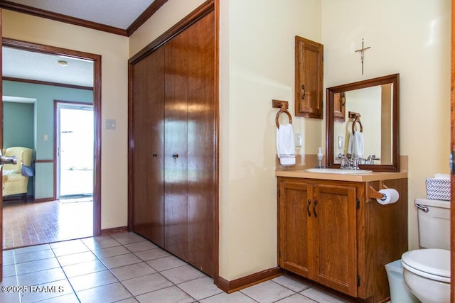 interior space featuring crown molding, light tile patterned floors, and baseboards