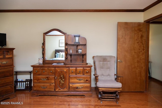sitting room featuring ornamental molding and wood finished floors