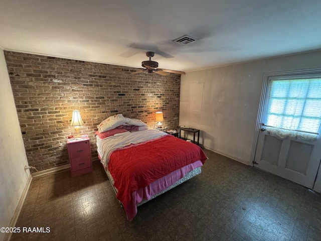 bedroom with a ceiling fan, dark floors, brick wall, visible vents, and baseboards