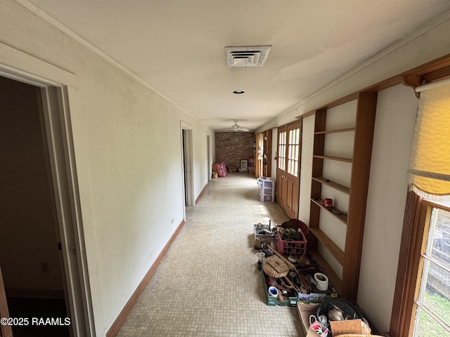 corridor with visible vents, baseboards, and a healthy amount of sunlight