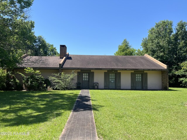 8133 Meadow Ln, Abbeville, LA 70510 - single story home with stucco siding, a chimney, and a front yard