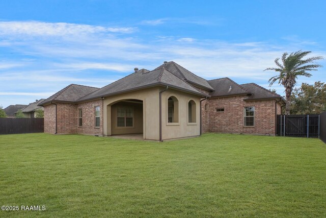 106 Rue De Chambery, Broussard, LA 70518 - back of house with a yard, a fenced backyard, brick siding, and a patio area