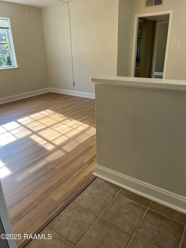 3121 Johnston St Unit 143, Lafayette, LA 70503 - unfurnished room with baseboards and dark wood finished floors