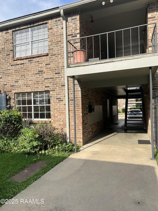 3121 Johnston St Unit 143, Lafayette, LA 70503 - view of side of home with a balcony and brick siding