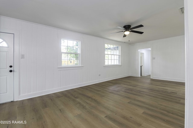empty room featuring visible vents, ceiling fan, wood finished floors, and baseboards