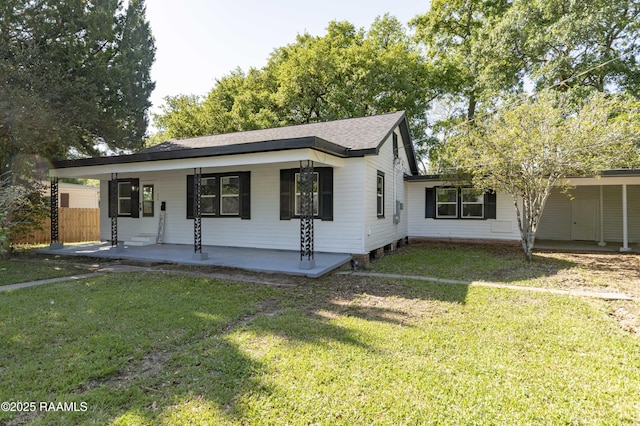 view of front facade with a patio area, a front lawn, and fence