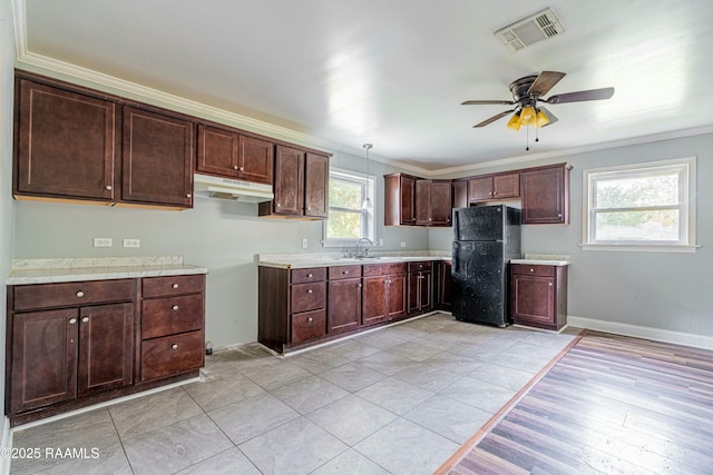 kitchen featuring crown molding, visible vents, ceiling fan, and freestanding refrigerator