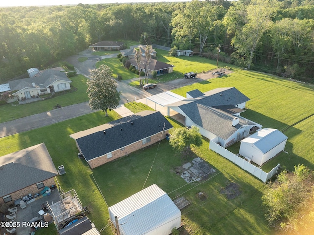 bird's eye view with a wooded view and a residential view
