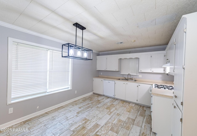 kitchen featuring white cabinets, dishwasher, a sink, light countertops, and crown molding