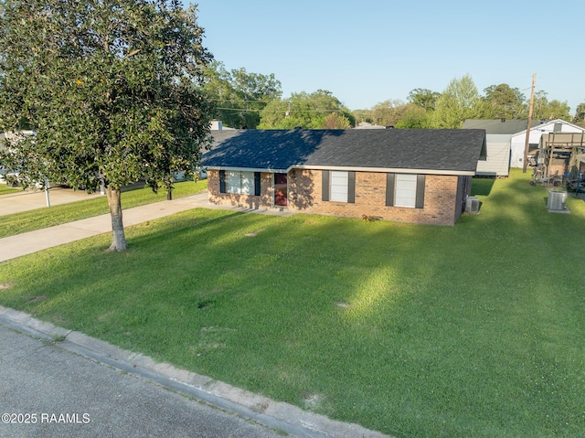 single story home featuring concrete driveway, a front yard, and brick siding
