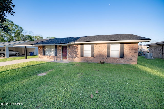 single story home featuring brick siding, driveway, cooling unit, and a front lawn