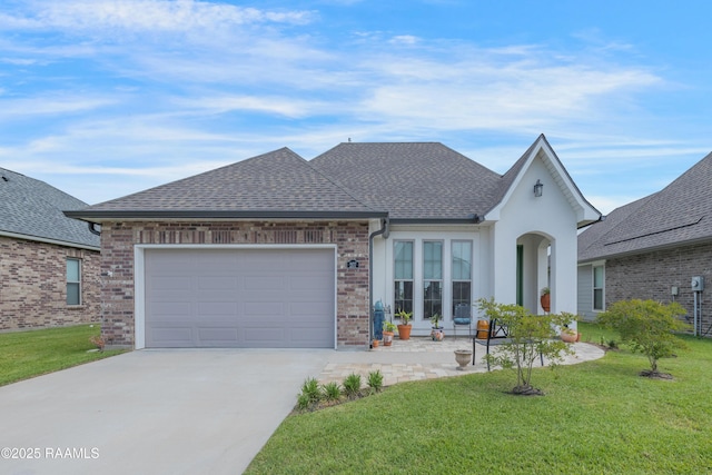 view of front facade featuring a garage, a front yard, brick siding, a shingled roof, and driveway