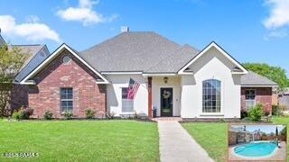 408 Gordon Crockett Dr, Lafayette, LA 70508 - view of front facade featuring a front yard and brick siding