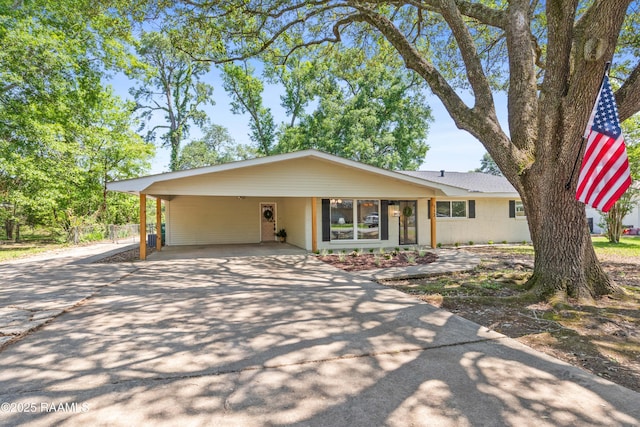 view of front of home with a carport and driveway