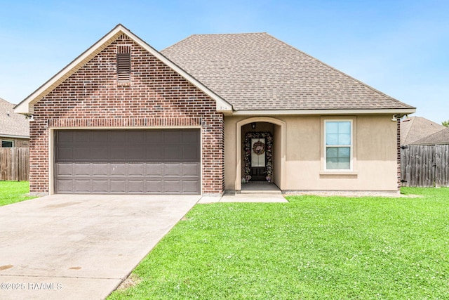 204 Stanwell Ave, Duson, LA 70529 - view of front facade with roof with shingles, concrete driveway, an attached garage, brick siding, and stucco siding