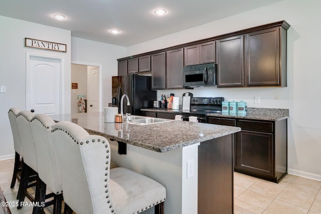 204 Stanwell Ave, Duson, LA 70529 - kitchen with black appliances, a sink, dark brown cabinets, a kitchen bar, and recessed lighting