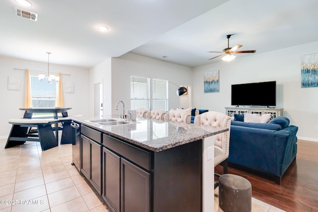 204 Stanwell Ave, Duson, LA 70529 - kitchen with a sink, a chandelier, a kitchen bar, a ceiling fan, and light stone counters