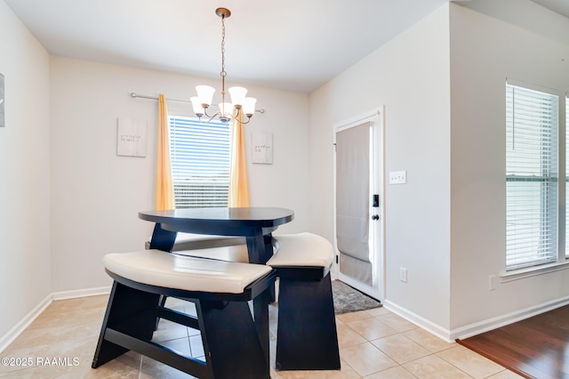 204 Stanwell Ave, Duson, LA 70529 - dining area featuring a chandelier, light tile patterned flooring, and baseboards