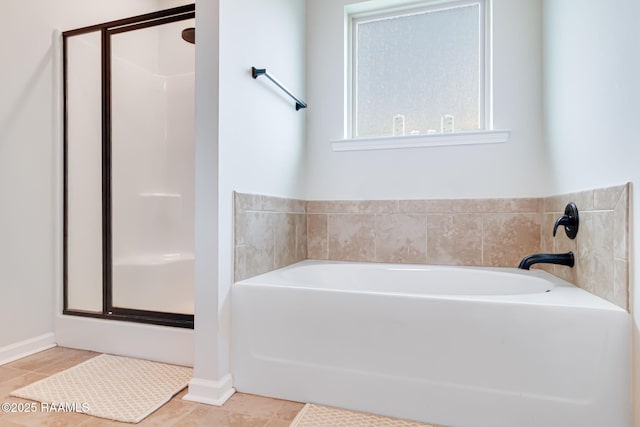 204 Stanwell Ave, Duson, LA 70529 - bathroom featuring a shower stall, a garden tub, and tile patterned floors