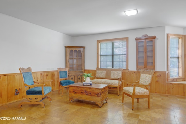 1119 Mary Lee St, Franklin, LA 70538 - living area with wooden walls, a wainscoted wall, and a healthy amount of sunlight