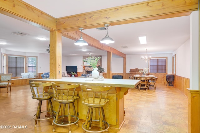 1119 Mary Lee St, Franklin, LA 70538 - kitchen with wooden walls, visible vents, a kitchen bar, and wainscoting