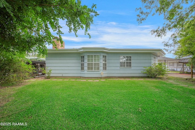 1119 Mary Lee St, Franklin, LA 70538 - rear view of house featuring a chimney and a yard