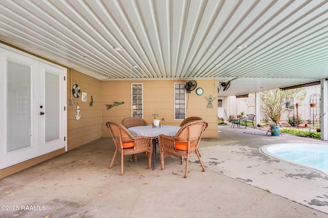 view of patio featuring an outdoor pool, french doors, and outdoor dining area