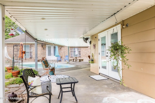 view of patio with french doors and an outdoor pool