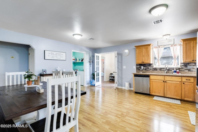 197 John Paul Dr, Opelousas, LA 70570 - kitchen featuring tasteful backsplash, french doors, light wood-style flooring, visible vents, and dishwasher