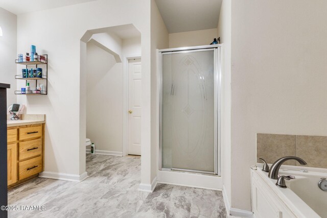 197 John Paul Dr, Opelousas, LA 70570 - bathroom with a stall shower, a garden tub, vanity, and baseboards