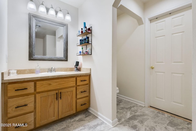 197 John Paul Dr, Opelousas, LA 70570 - bathroom featuring toilet, marble finish floor, vanity, and baseboards
