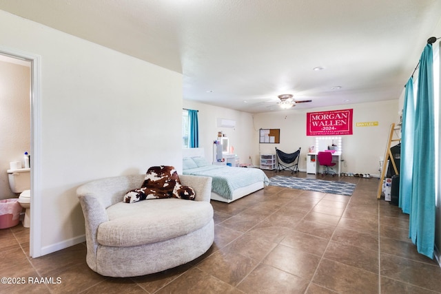 197 John Paul Dr, Opelousas, LA 70570 - bedroom with tile patterned flooring, baseboards, connected bathroom, and ceiling fan