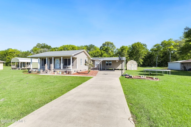 197 John Paul Dr, Opelousas, LA 70570 - view of front of home with a storage shed, an outdoor structure, a porch, a trampoline, and driveway