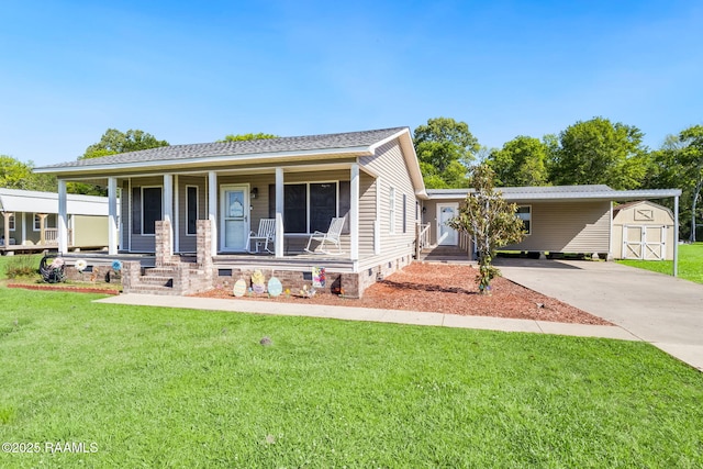 197 John Paul Dr, Opelousas, LA 70570 - view of front of house with a front yard, a shed, a porch, concrete driveway, and an outbuilding