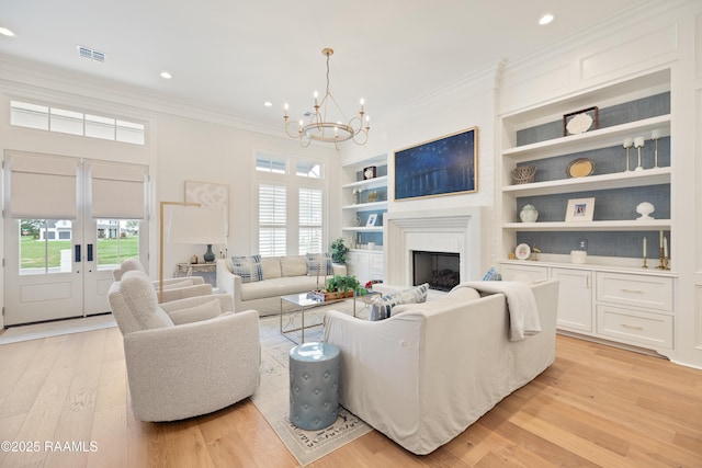 211 Crossbill Dr, Lafayette, LA 70508 - living room with light wood finished floors, built in features, ornamental molding, and a healthy amount of sunlight
