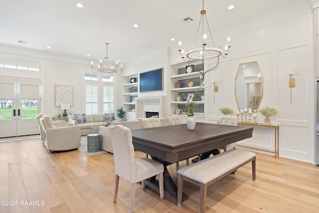 211 Crossbill Dr, Lafayette, LA 70508 - dining area with recessed lighting, visible vents, light wood-style flooring, built in shelves, and a notable chandelier