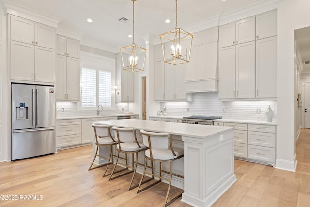 211 Crossbill Dr, Lafayette, LA 70508 - kitchen with tasteful backsplash, stainless steel appliances, a kitchen island, and light countertops