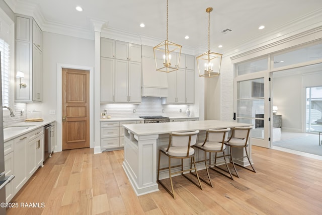 211 Crossbill Dr, Lafayette, LA 70508 - kitchen featuring stainless steel dishwasher, a sink, visible vents, backsplash, and light countertops