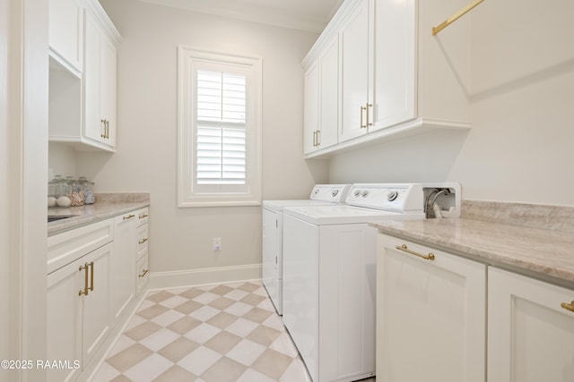 211 Crossbill Dr, Lafayette, LA 70508 - clothes washing area featuring light floors, washing machine and dryer, crown molding, baseboards, and cabinet space