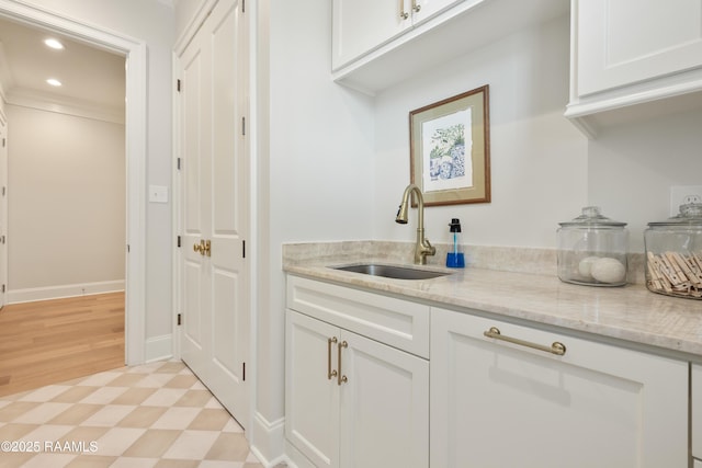 211 Crossbill Dr, Lafayette, LA 70508 - bar featuring a sink, light floors, baseboards, ornamental molding, and recessed lighting