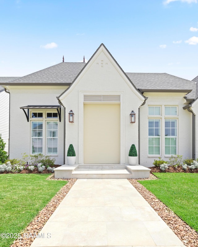 211 Crossbill Dr, Lafayette, LA 70508 - view of front of property featuring an attached garage, a shingled roof, and a front lawn