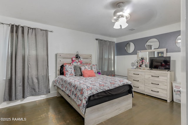 bedroom featuring wood finished floors and visible vents