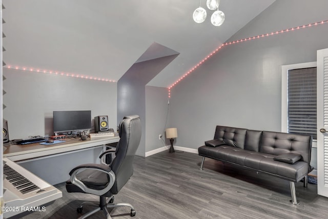 home office featuring wood finished floors, baseboards, and vaulted ceiling